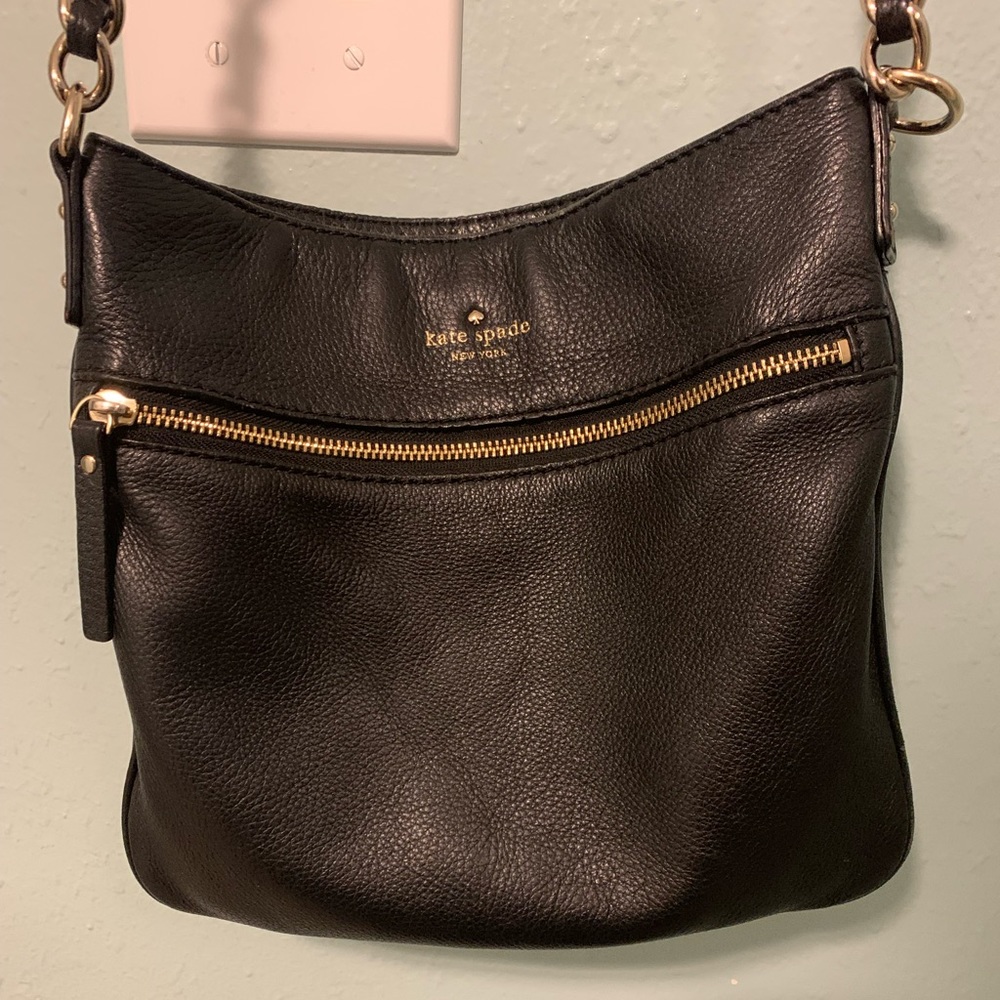 Kate Spade cross body. Measures 10x10”, clean. Fun stripe pattern inside.
